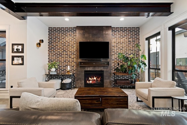 living room with a large fireplace and brick wall