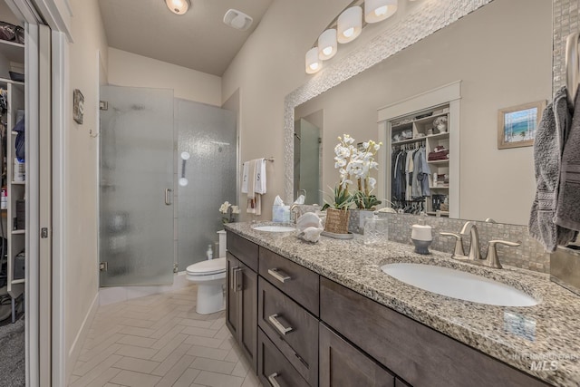 420 Poppy St, Fruitland, ID 83619 - bathroom with a stall shower, toilet, double vanity, and a spacious closet