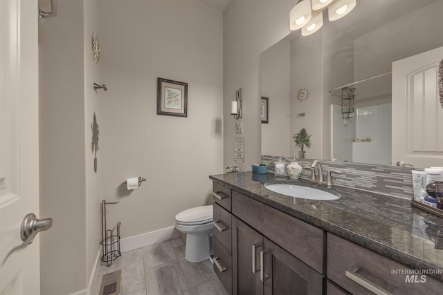 420 Poppy St, Fruitland, ID 83619 - bathroom featuring baseboards, toilet, and vanity