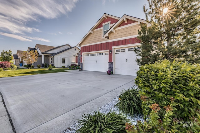 420 Poppy St, Fruitland, ID 83619 - view of front of house featuring concrete driveway, board and batten siding, stone siding, and an attached garage
