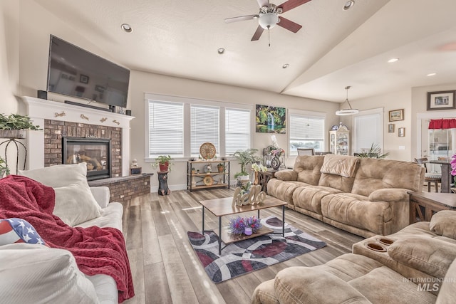 420 Poppy St, Fruitland, ID 83619 - living area with lofted ceiling, ceiling fan, recessed lighting, wood finished floors, and a brick fireplace