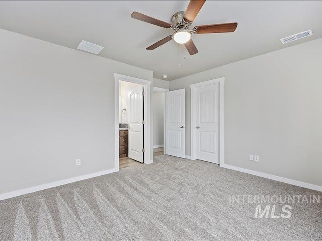 unfurnished bedroom with visible vents, connected bathroom, light carpet, and baseboards