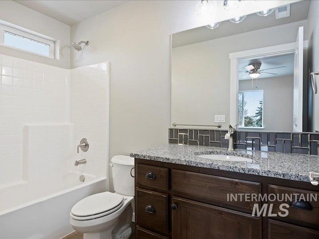 full bathroom with ceiling fan, toilet, visible vents, vanity, and bathing tub / shower combination