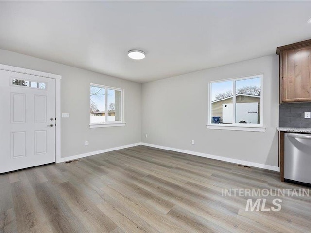 entrance foyer featuring light wood-style floors, visible vents, and baseboards