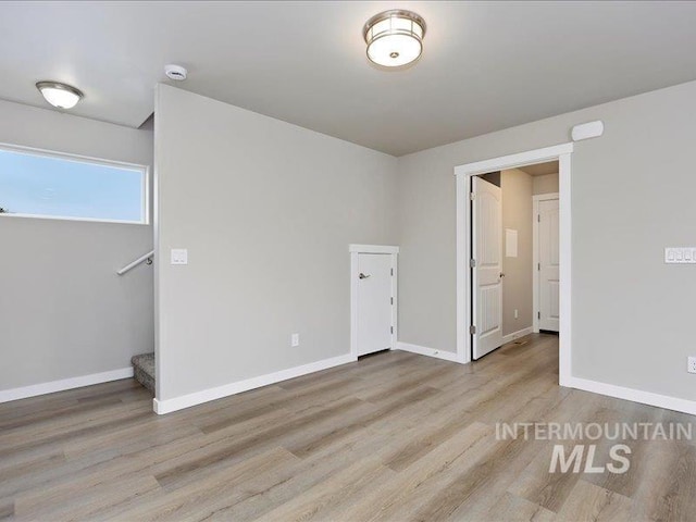 unfurnished bedroom with baseboards and light wood finished floors