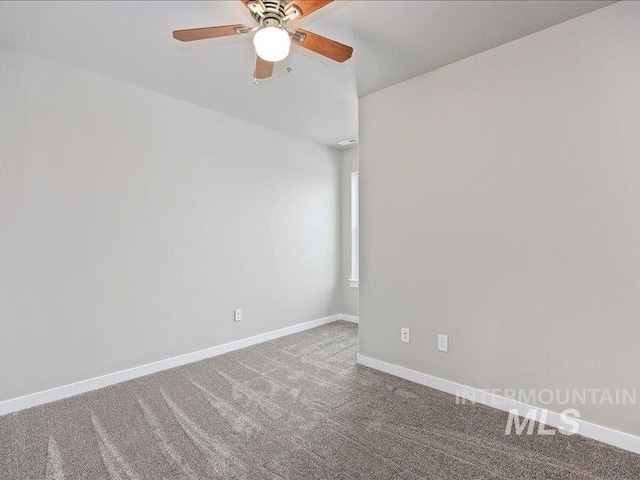 carpeted empty room with a ceiling fan and baseboards