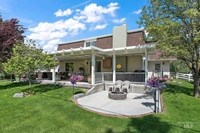 4545 N Columbine St, Boise, ID 83646 - rear view of property with an outdoor fire pit, a shingled roof, a patio, and a yard