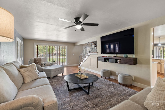 4545 N Columbine St, Boise, ID 83646 - living room featuring stairway, wood finished floors, ceiling fan, baseboards, and a textured ceiling