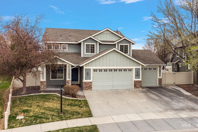 1452 E Pistioa Dr, Meridian, ID 83642 - craftsman-style home with board and batten siding, stone siding, a shingled roof, driveway, and an attached garage
