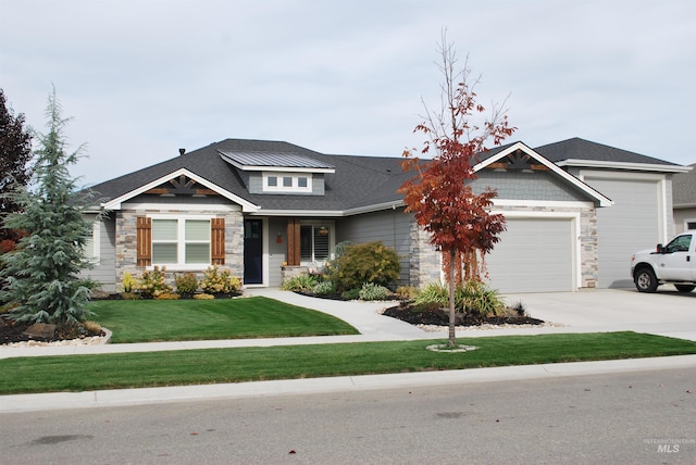 view of front of home with stone siding, an attached garage, concrete driveway, and a front lawn