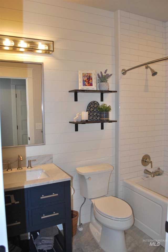 bathroom featuring toilet, shower / washtub combination, and vanity