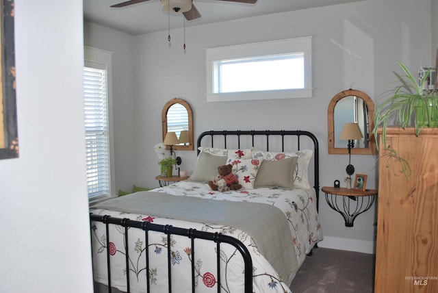 bedroom with a ceiling fan, baseboards, and carpet floors