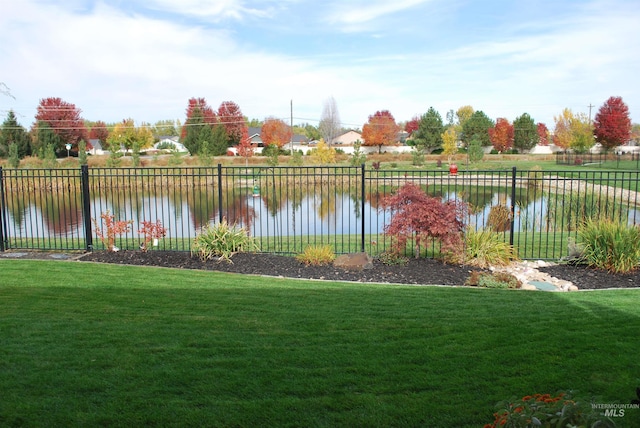 view of yard with fence and a water view