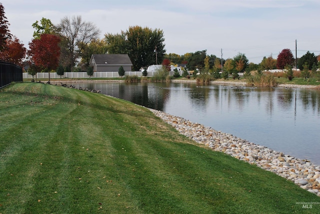 property view of water featuring fence