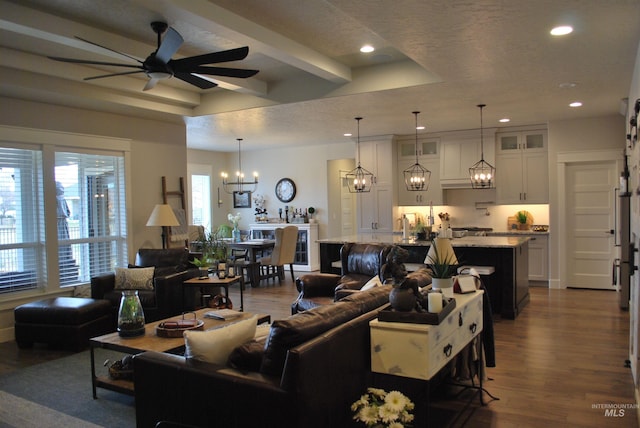 living room with recessed lighting, ceiling fan with notable chandelier, and dark wood-style flooring