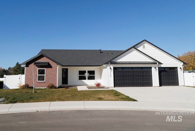 single story home with a front yard and a garage