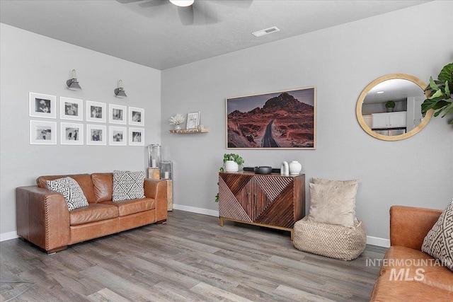 living area with wood finished floors and baseboards