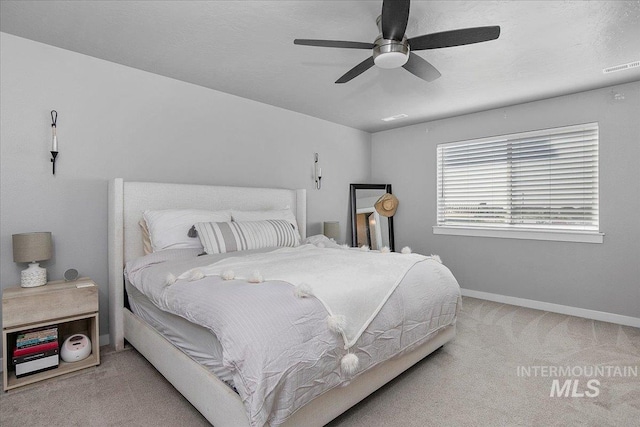 bedroom featuring a ceiling fan, carpet, visible vents, and baseboards