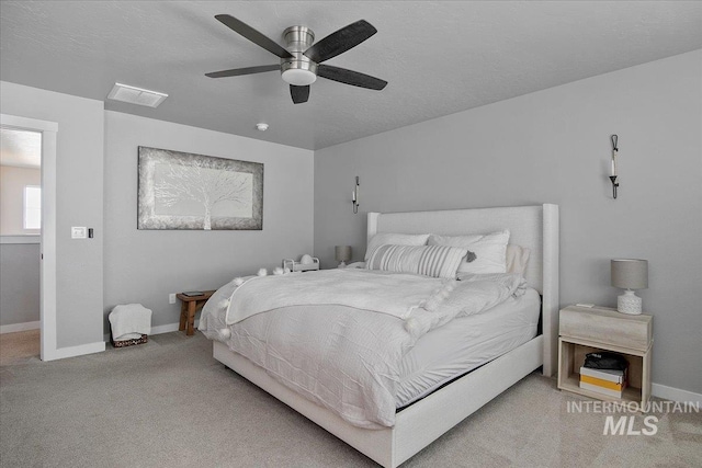 bedroom featuring carpet, visible vents, a ceiling fan, a textured ceiling, and baseboards