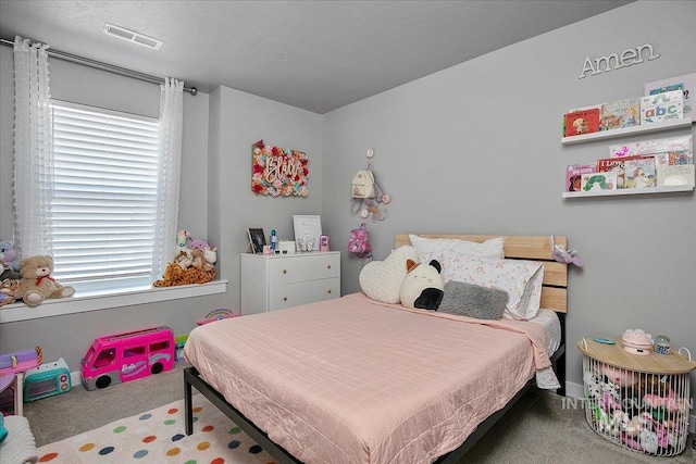 bedroom featuring a textured ceiling, carpet floors, and visible vents