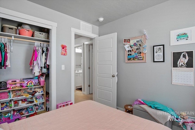 bedroom featuring a closet, carpet flooring, and visible vents