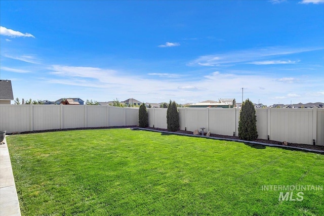 view of yard with a fenced backyard