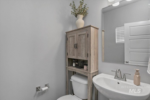 bathroom featuring toilet and a sink