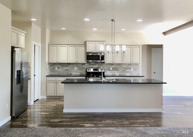 1756 N Hornback Ave, Star, ID 83669 - kitchen featuring appliances with stainless steel finishes, dark countertops, a sink, decorative backsplash, and recessed lighting