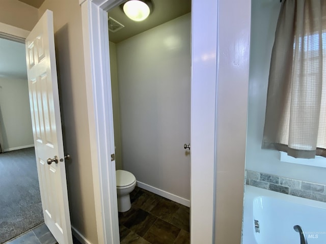 1756 N Hornback Ave, Star, ID 83669 - bathroom featuring toilet, a tub, and baseboards