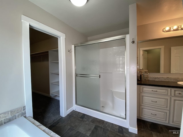1756 N Hornback Ave, Star, ID 83669 - full bathroom featuring a shower stall, vanity, a walk in closet, and a tub to relax in