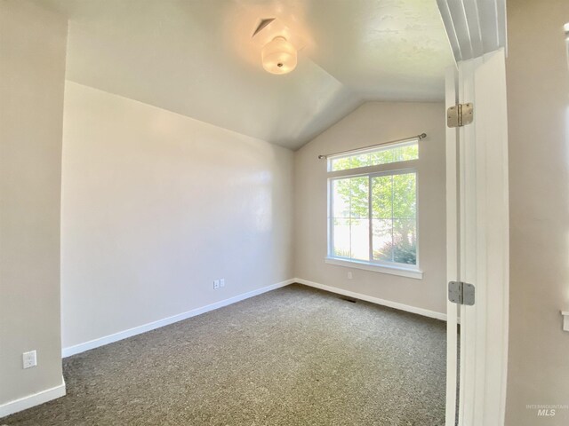 1756 N Hornback Ave, Star, ID 83669 - empty room with dark colored carpet, baseboards, and lofted ceiling