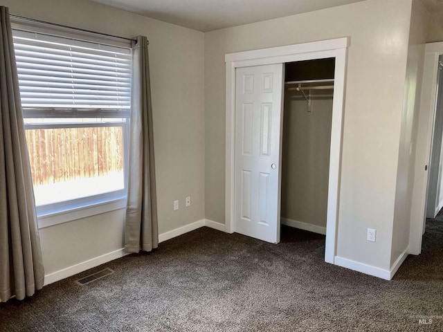 1756 N Hornback Ave, Star, ID 83669 - unfurnished bedroom with dark carpet, a closet, and baseboards