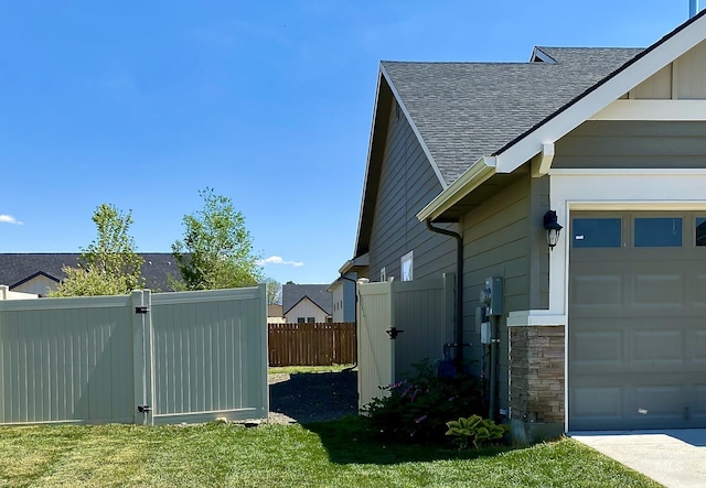 1756 N Hornback Ave, Star, ID 83669 - view of property exterior featuring a shingled roof, a gate, stone siding, and a garage