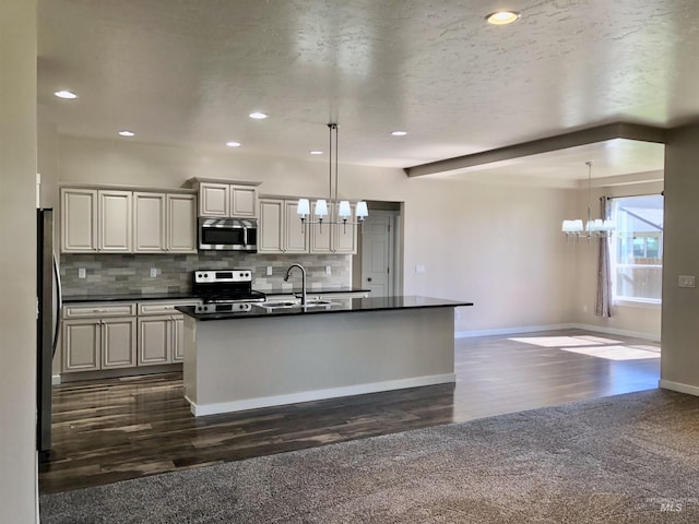1756 N Hornback Ave, Star, ID 83669 - kitchen featuring a chandelier, appliances with stainless steel finishes, dark countertops, dark wood finished floors, and recessed lighting