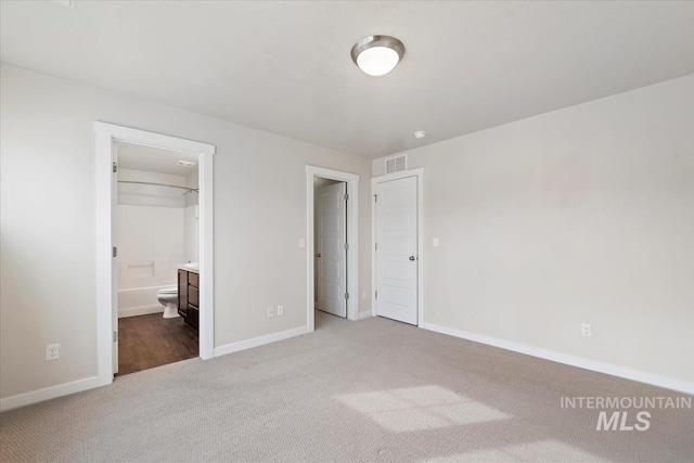 unfurnished bedroom featuring visible vents, baseboards, and carpet flooring