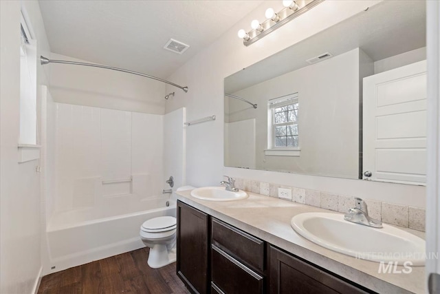 full bathroom featuring visible vents, toilet, and a sink