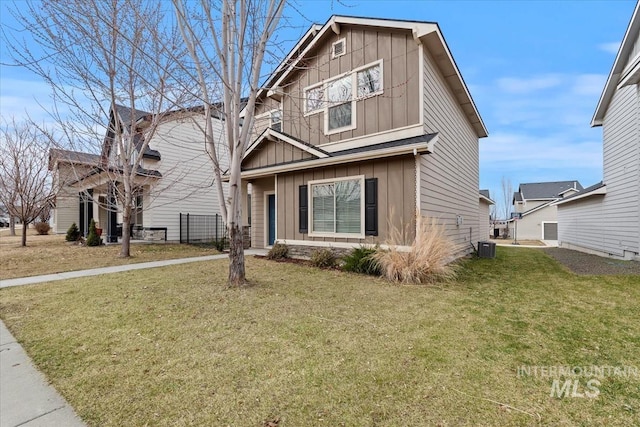 view of front facade featuring cooling unit, board and batten siding, and a front yard