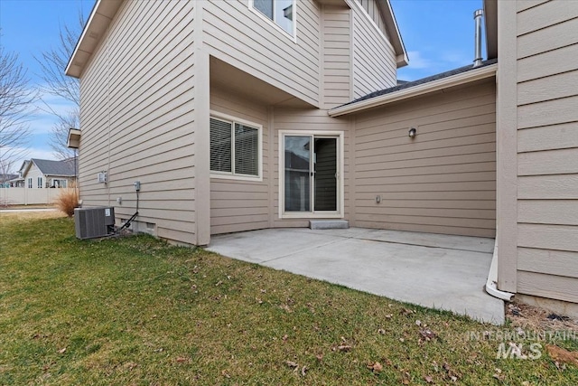 rear view of property featuring a yard, a patio area, and central AC