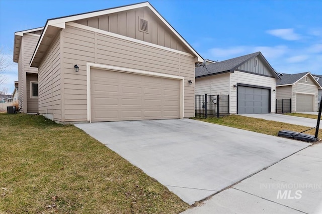 view of front of house with board and batten siding, central AC, a front yard, and concrete driveway