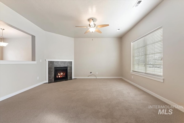 unfurnished living room featuring visible vents, baseboards, and carpet