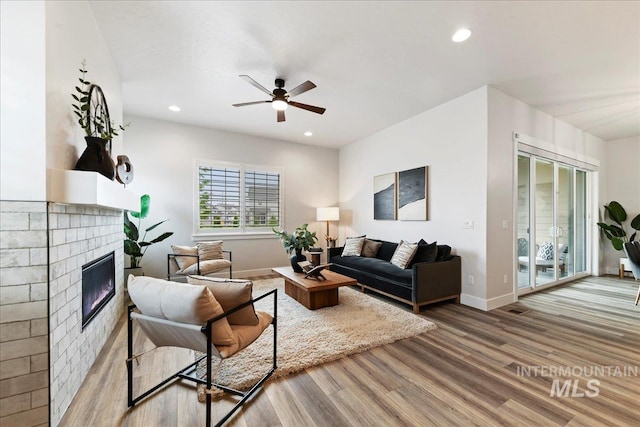 living room featuring hardwood / wood-style flooring and ceiling fan