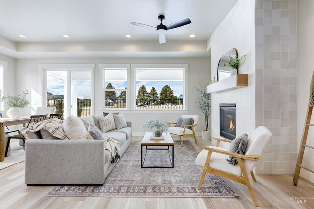 652 N Morning Glory, Eagle, ID 83616 - living room featuring a wealth of natural light, a glass covered fireplace, ceiling fan, and light wood finished floors