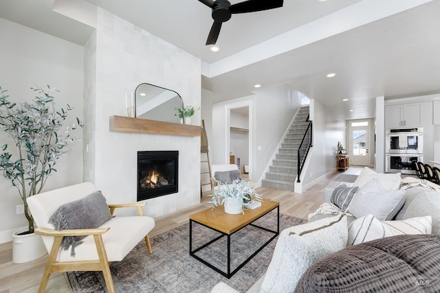 652 N Morning Glory, Eagle, ID 83616 - living area with stairs, a tiled fireplace, light wood-type flooring, ceiling fan, and recessed lighting