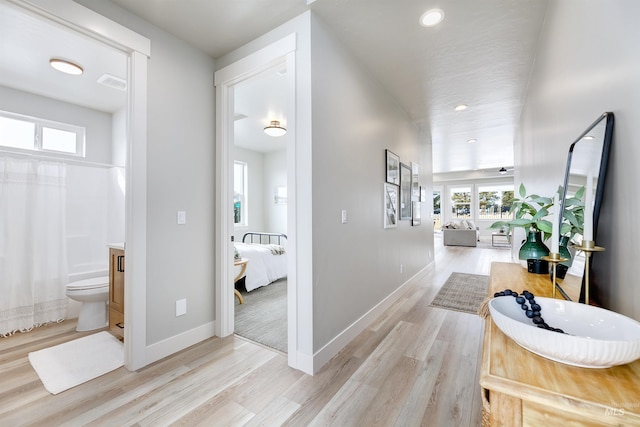 652 N Morning Glory, Eagle, ID 83616 - corridor with plenty of natural light, baseboards, light wood-style floors, and visible vents