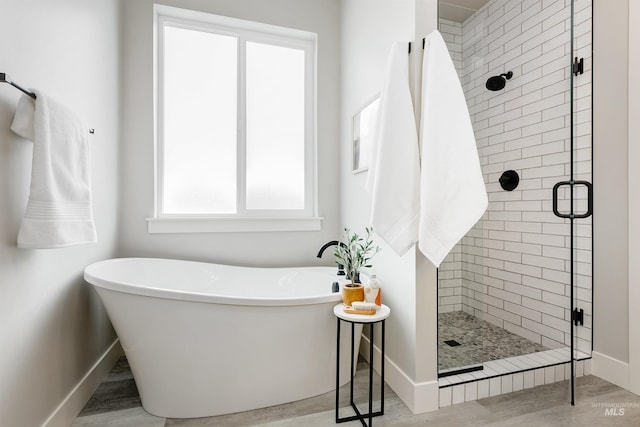 652 N Morning Glory, Eagle, ID 83616 - bathroom featuring a stall shower, baseboards, a freestanding bath, and wood finished floors