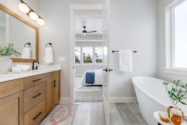 652 N Morning Glory, Eagle, ID 83616 - full bathroom featuring baseboards, wood finished floors, vanity, a freestanding bath, and ensuite bath