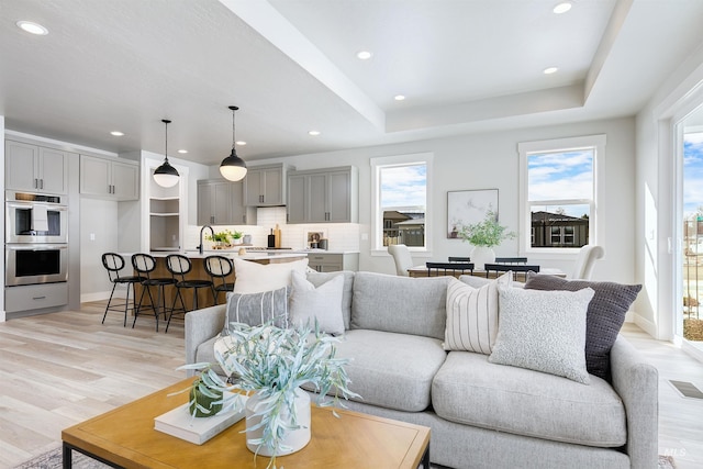 652 N Morning Glory, Eagle, ID 83616 - living area featuring visible vents, light wood-style flooring, baseboards, recessed lighting, and a raised ceiling