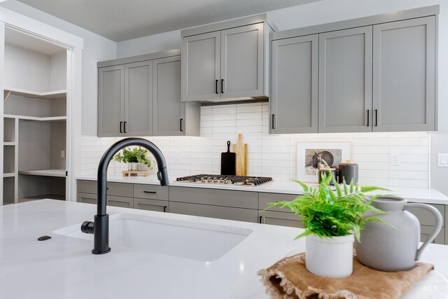 652 N Morning Glory, Eagle, ID 83616 - kitchen featuring gray cabinetry, light countertops, a sink, and stainless steel gas stovetop