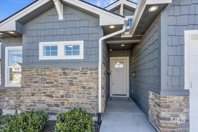 doorway to property with stone siding