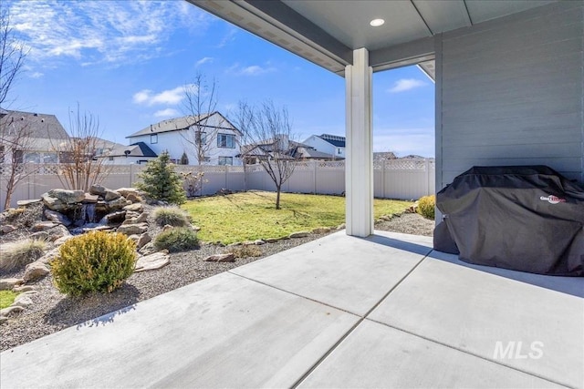 view of patio / terrace with grilling area and a fenced backyard